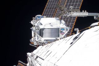 The Alpha Magnetic Spectrometer (AMS) as seen mounted outside the International Space Station prior to the first spacewalk to repair the cosmic ray detector on Friday, Nov. 15, 2019.