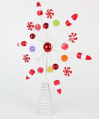 A snowflake shaped metal Christmas tree topper decoration with assortment of confectionery decor