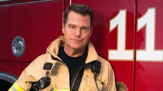 Chris O'Donnell posing against a fire truck for 9-1-1: Nashville