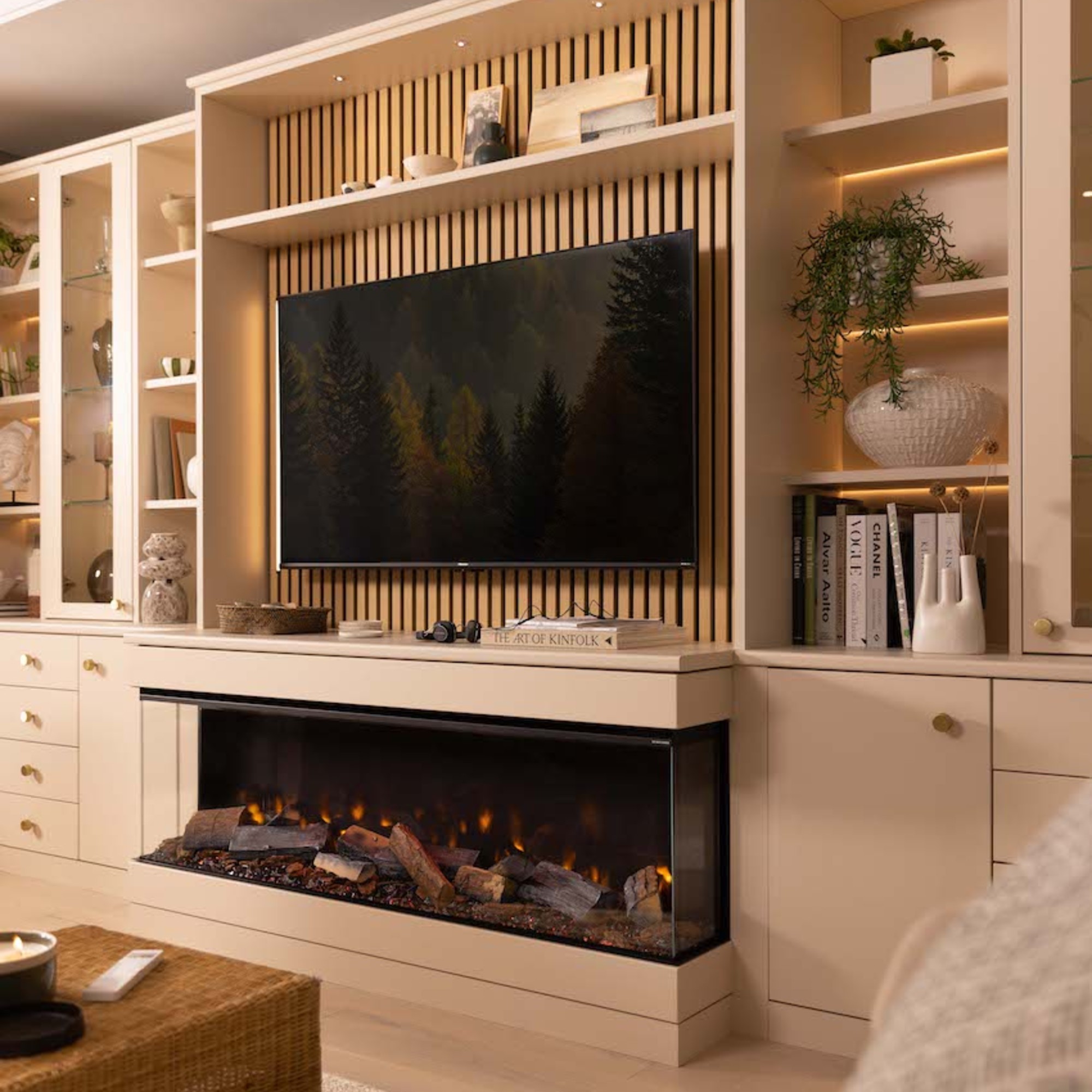 An electric fireplace from Sharps integrated into a living room media unit with a TV above