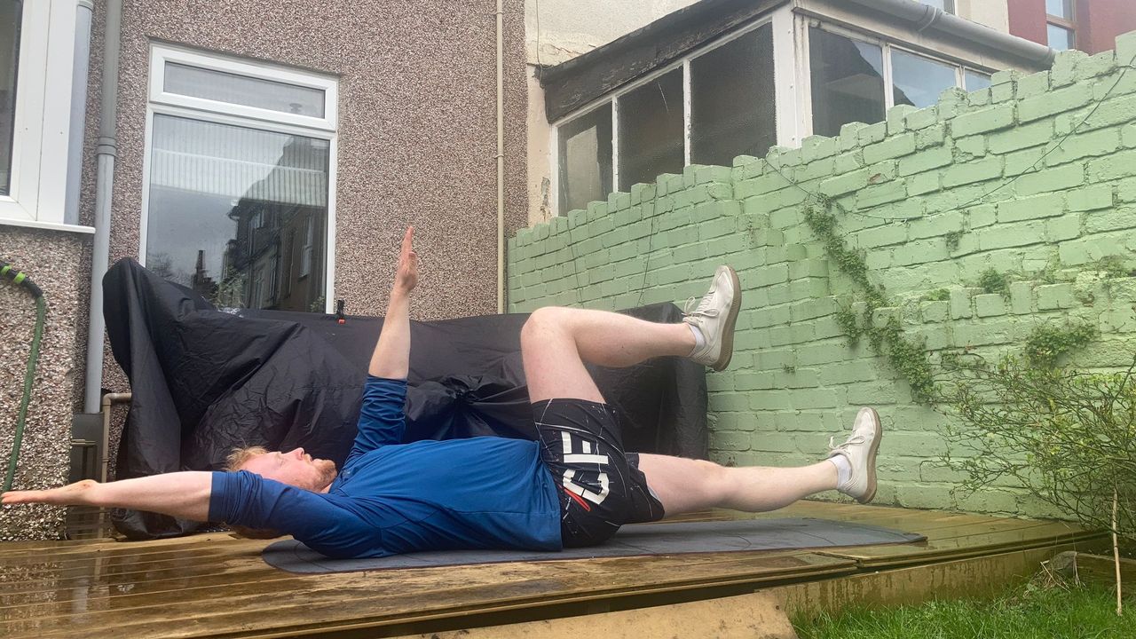 Fit&amp;Well fitness writer Harry Bullmore demonstrating a dead bug