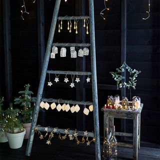 Outdoor Christmas lighting ideas with ladder and lights