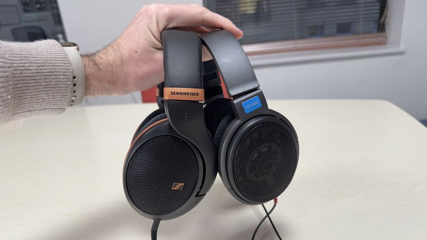 Sennheiser HD 505 and HD 600 headphones held in a man&#039;s hand