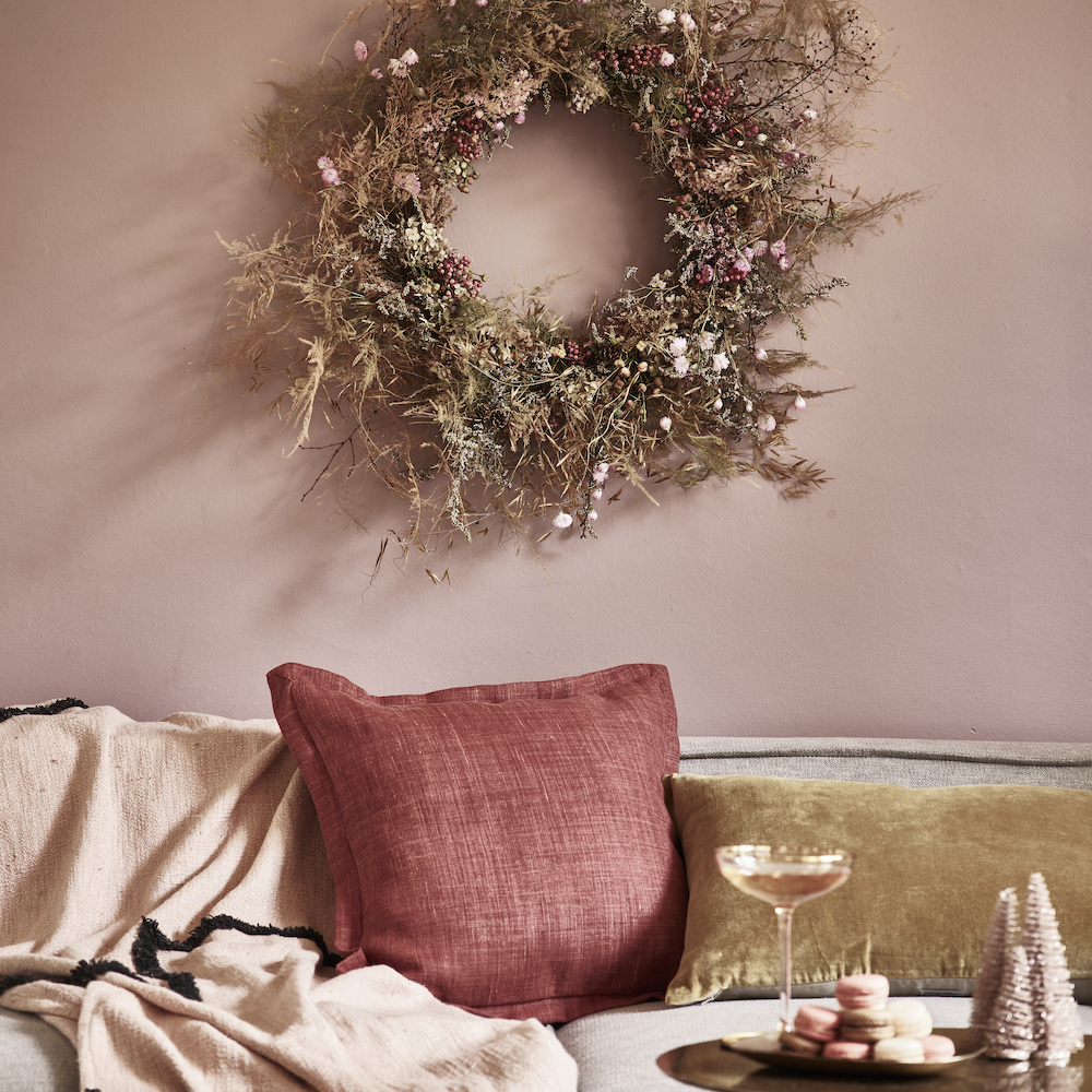 dried foliage wreath above a sofa