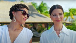 Kiara Barnes and Roselyn Sánchez stand outside smiling contently in Fantasy Island.