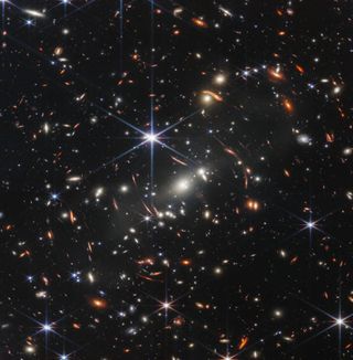 Hundreds of tiny galaxies sparkling like stars.