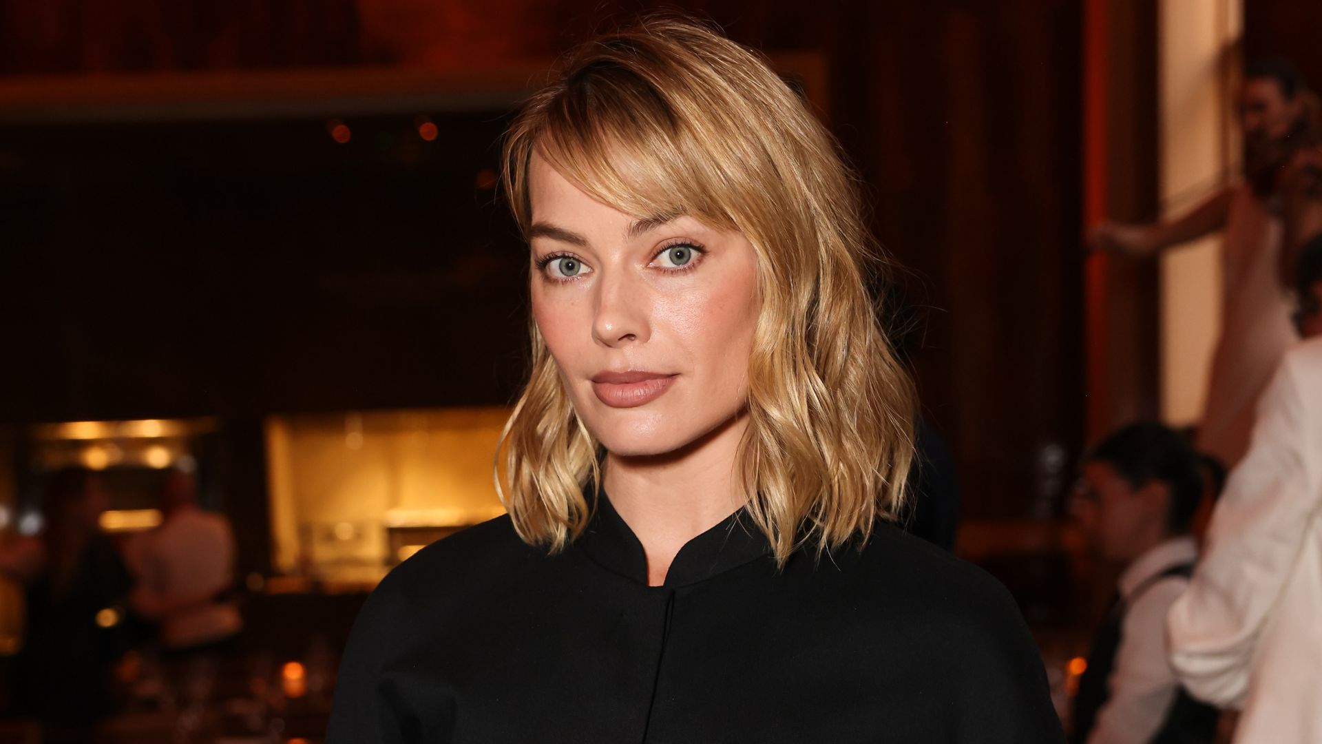 An image of Margot Robbie wearing culottes with court heels whilst in London. 