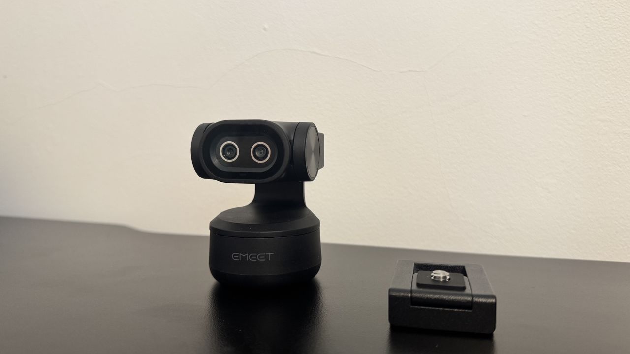 The Emeet Pixy 4K webcam and its stand, on a black desk.