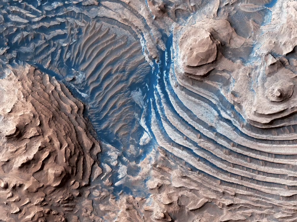 An aerial image showing stepped layers of rock on Mars