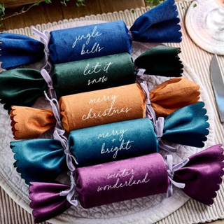 A set of five reuseable velvet Christmas crackers in pastel tones