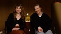a woman and a man in a press conference room