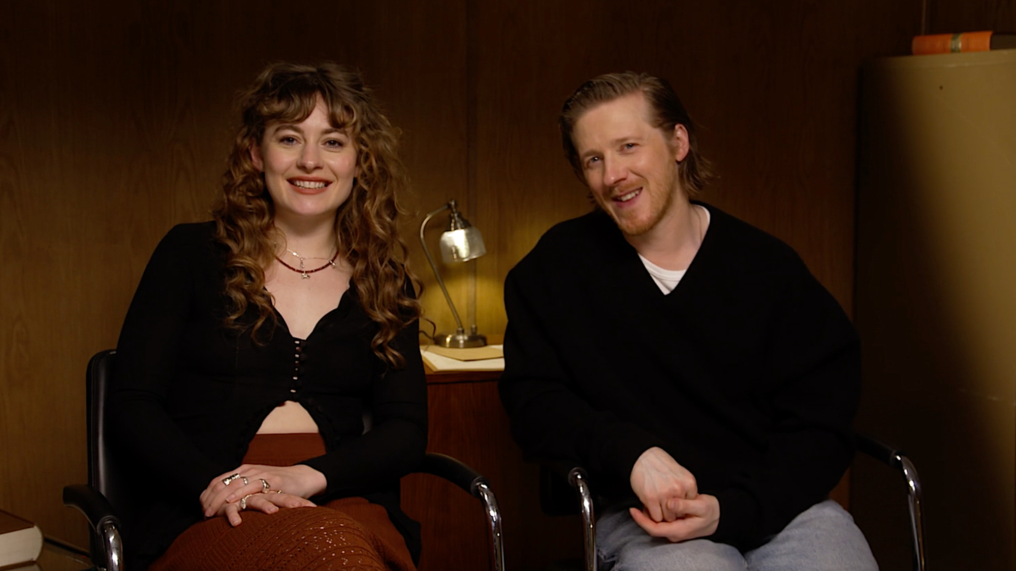 a woman and a man in a press conference room