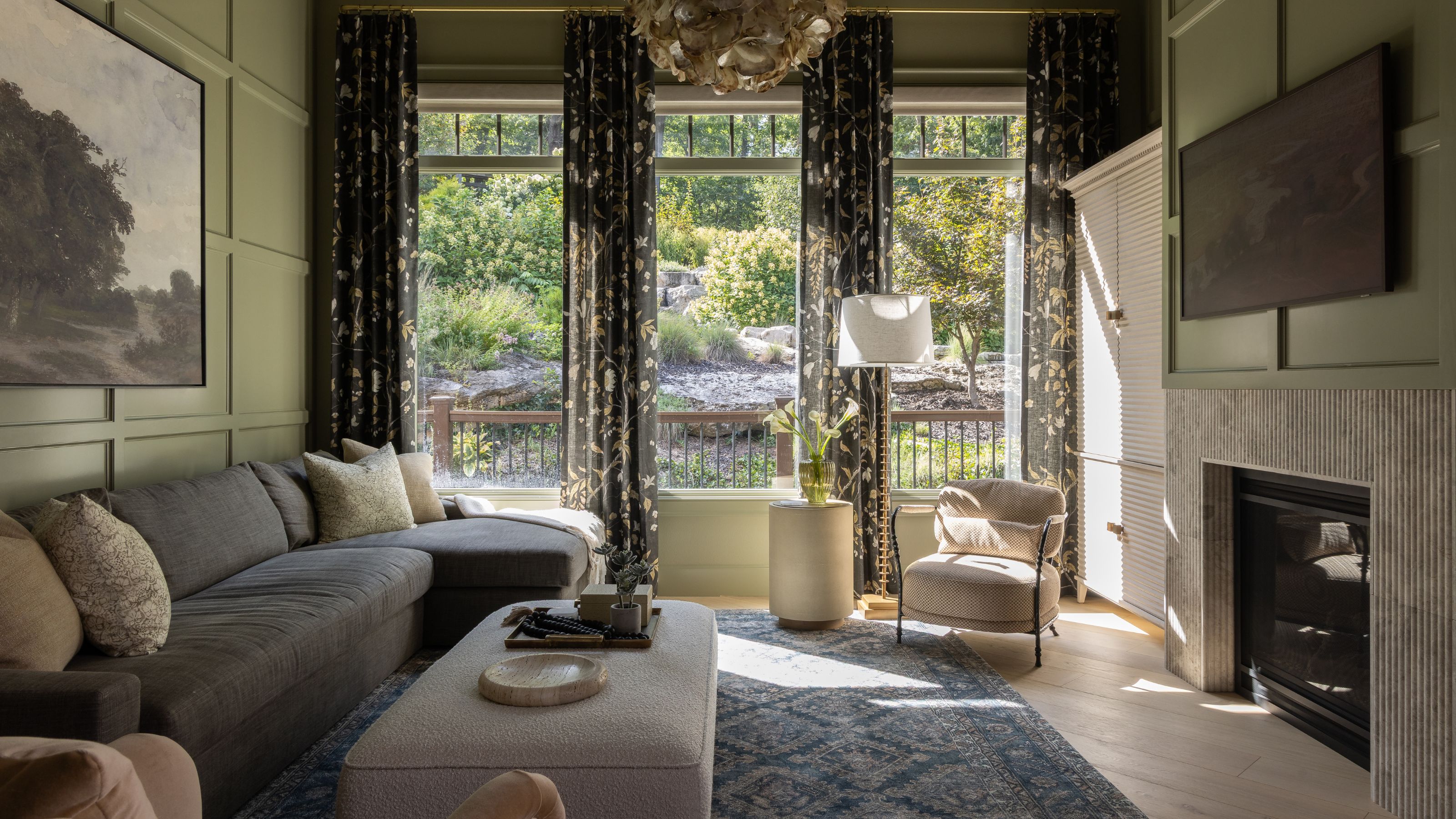 the 'keeping room' in a large Missouri home with glass windows looking out to the surrounding woodlands