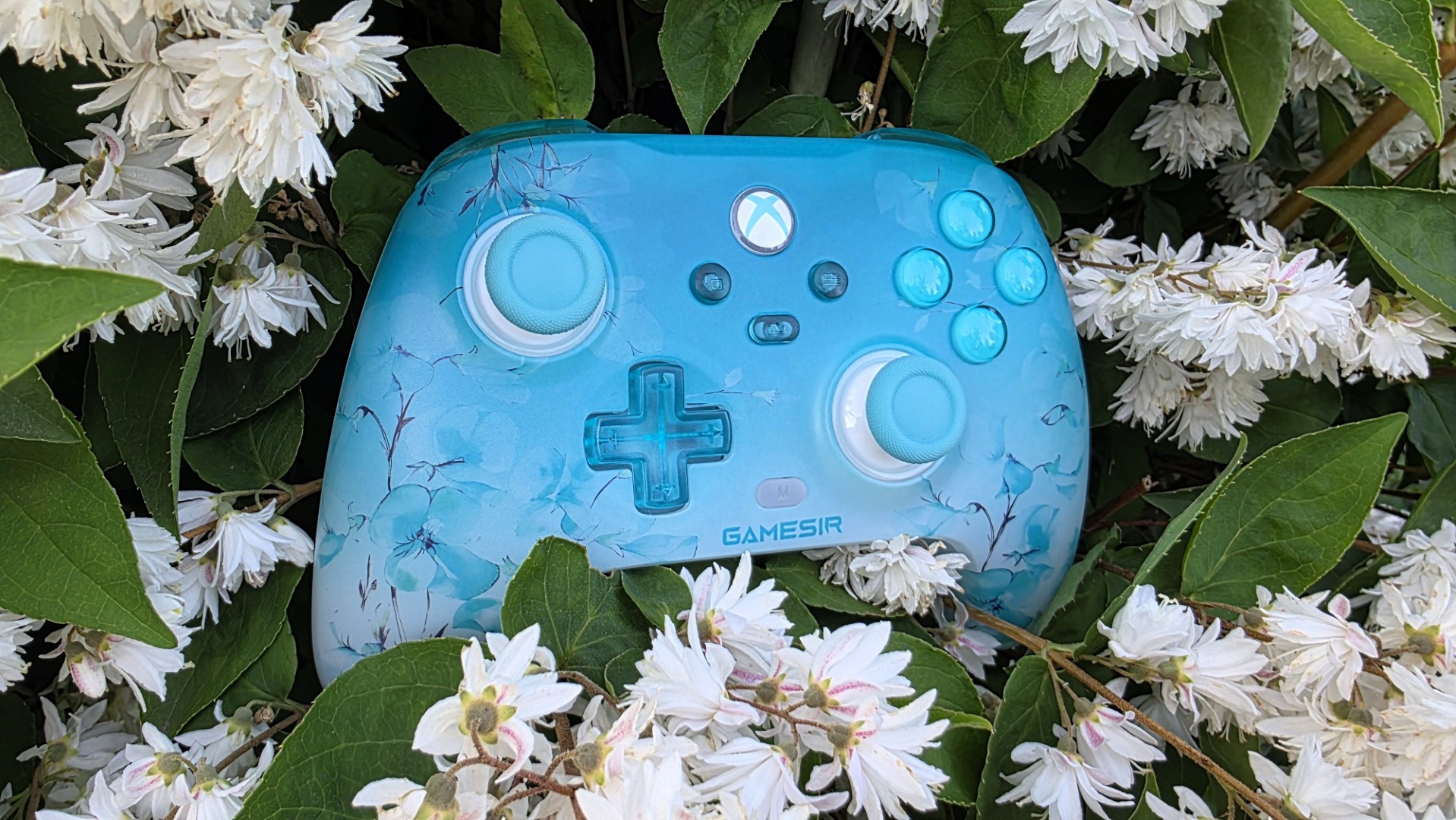 A blue and white controller with floral pattern