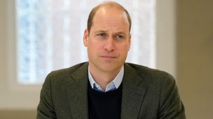 Prince William, Prince of Wales listens to members of staff as he visits Depaul UK in January 2023