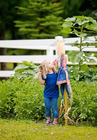 How to make a scarecrow: girl with small scarecrow