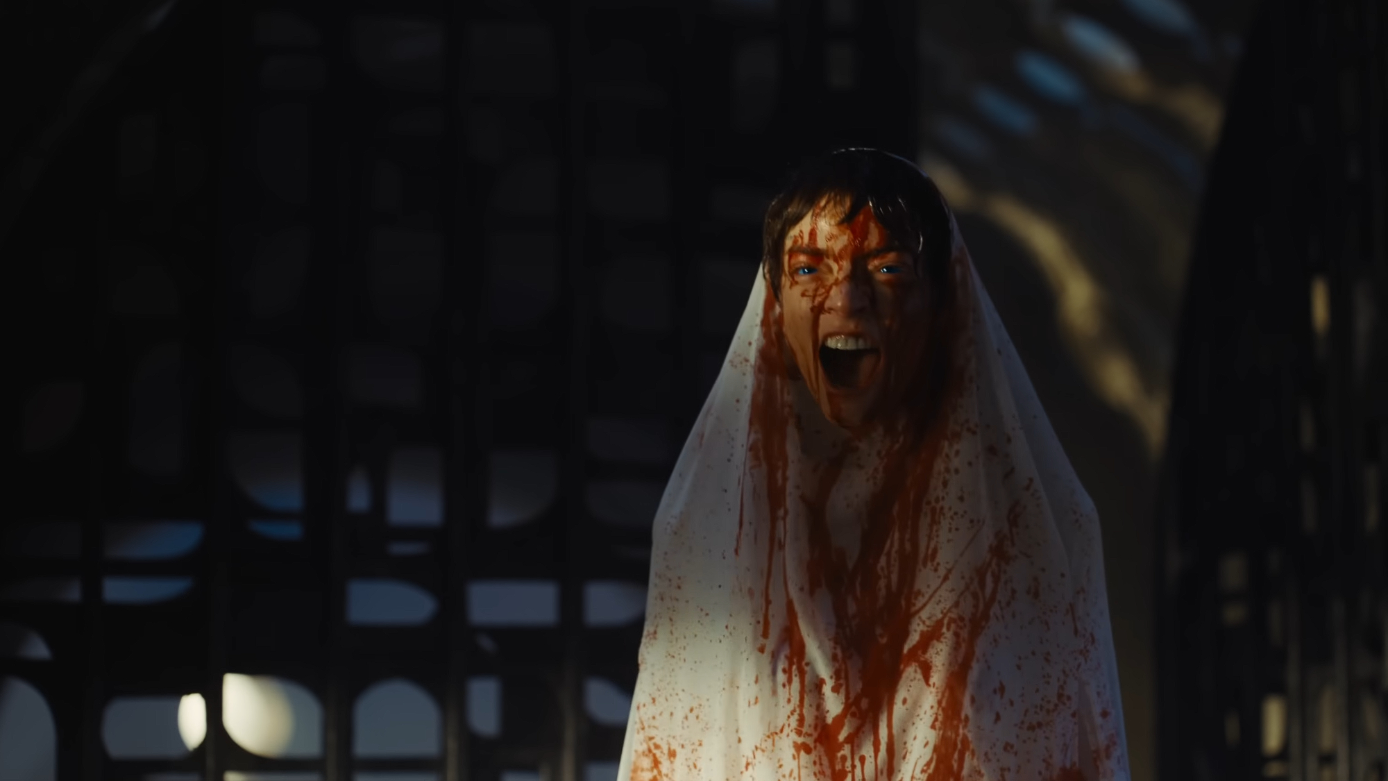 a woman in a white sheet covered in blood