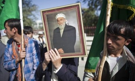 Supporters of Burhanuddin Rabbani stand outside the former Afghan president&amp;#039;s house a day after he was killed by a suicide bomber