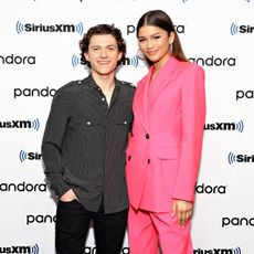 Zendaya and Tom Holland pose together on a red carpet