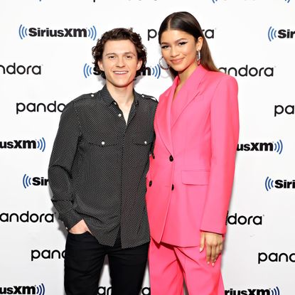 Zendaya and Tom Holland pose together on a red carpet