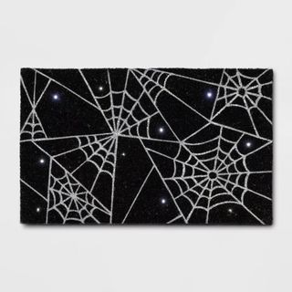 Halloween Spiderwebs Light-Up Doormat Black against a gray background.