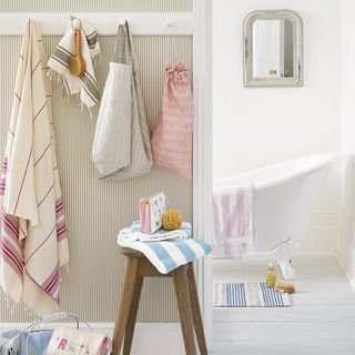 white bathroom with table and towels