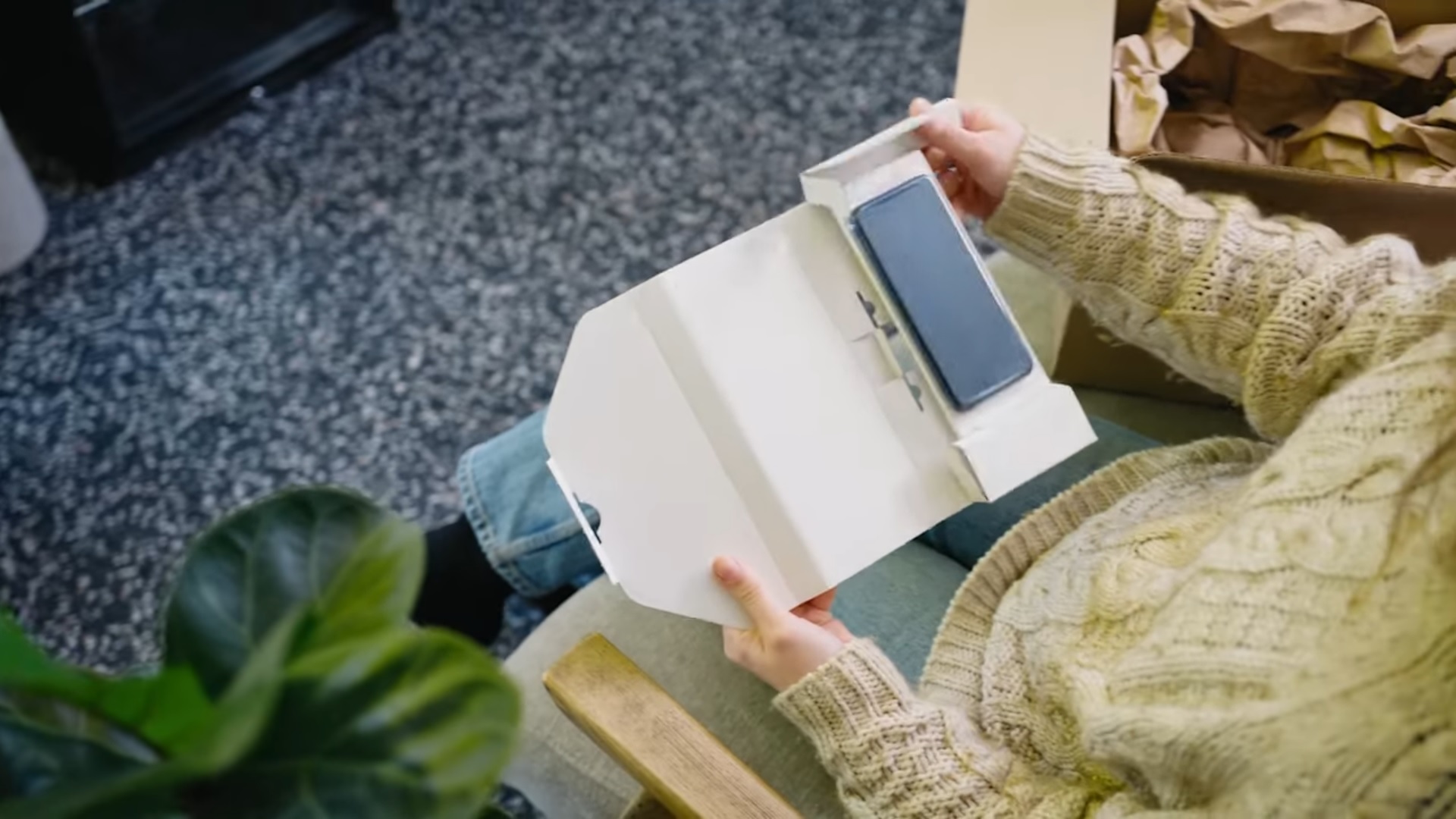 Woman opening a refurbished phone delivery