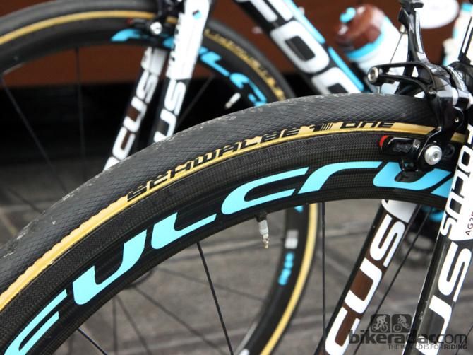 While standard Schwalbe One HT tubulars are all black, these team-edition tires get tan sidewalls, along with what appears to be a hand-glued tread cap