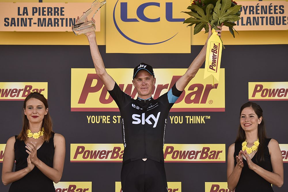 Chris Froome stands on the podium as the stage 10 winner
