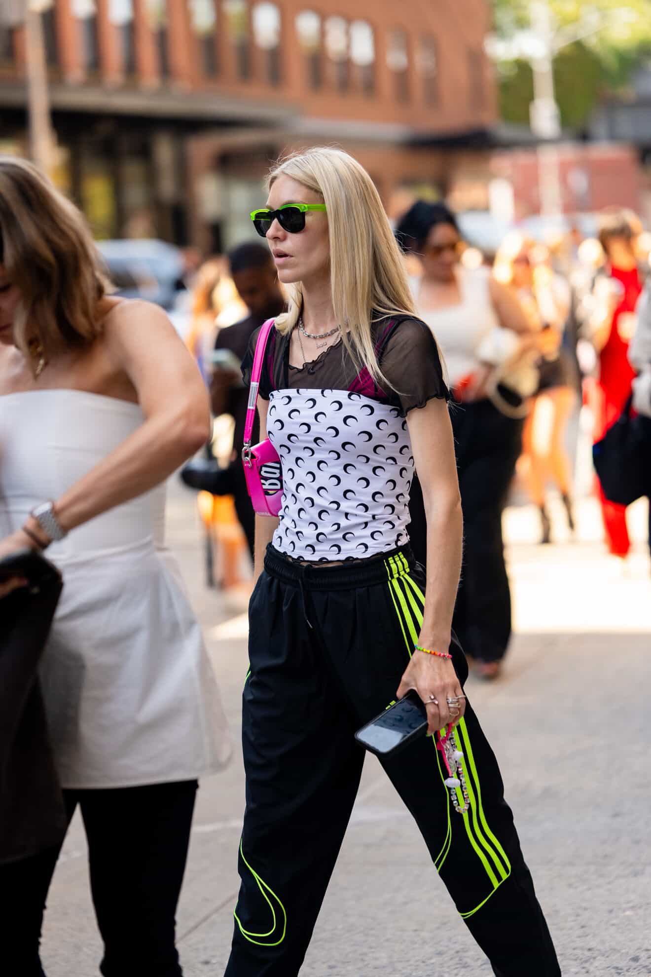 Jessica minkoff at fashion week wearing neon sunglasses, marine serre top, adidas track pants