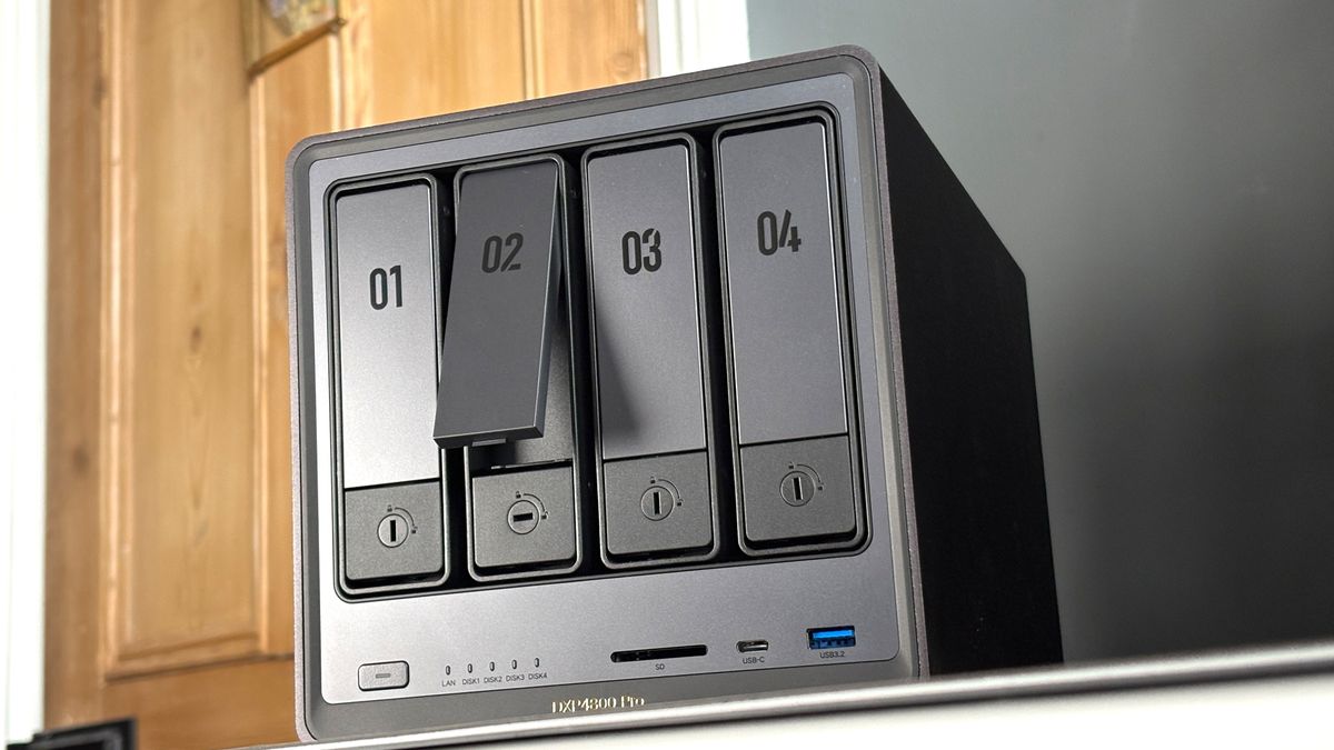 UGreen NASync DXP4800 Pro on a desk with multiple HDDs installed.