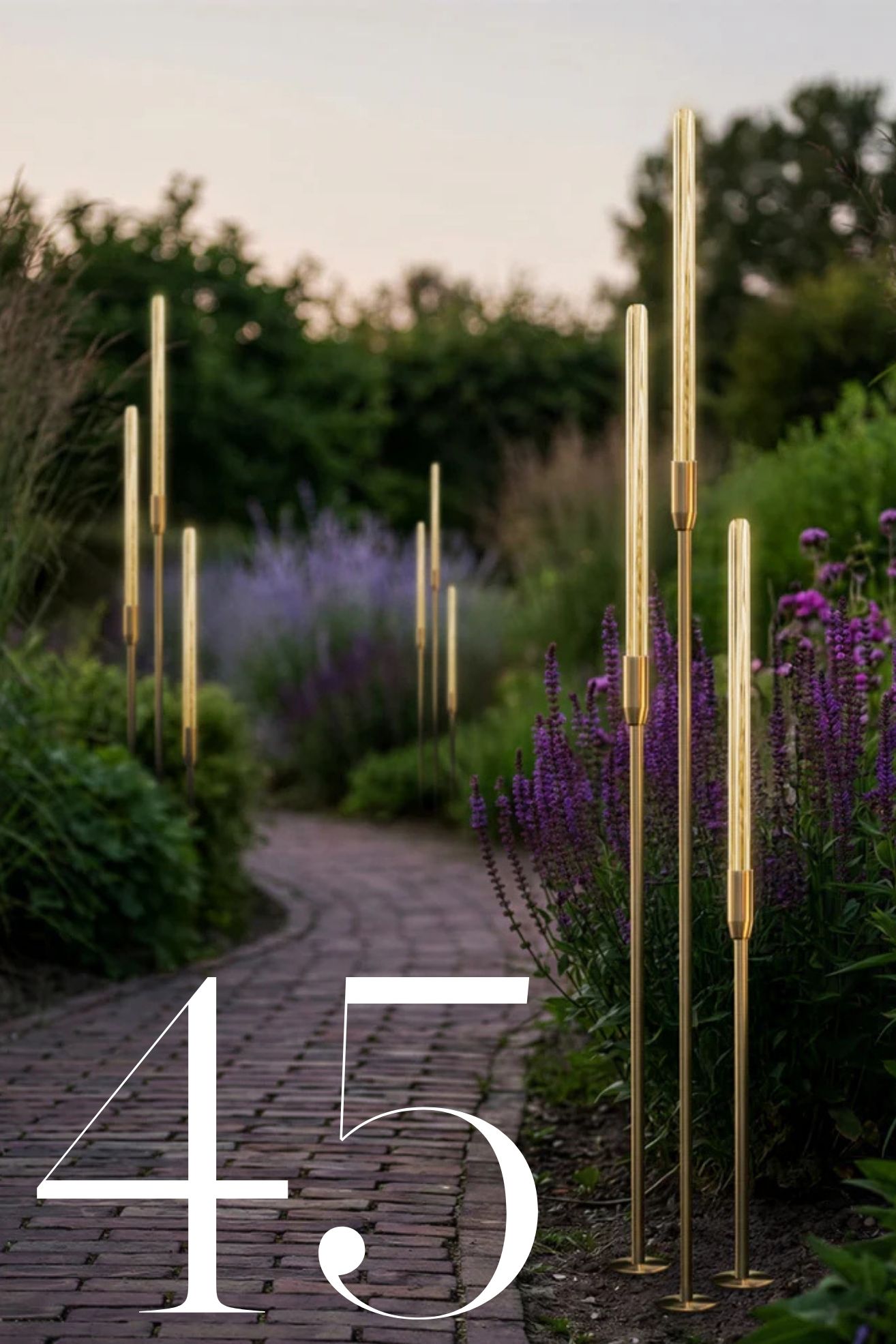 garden path with purple flowers on either side with bullrush outdoor lights