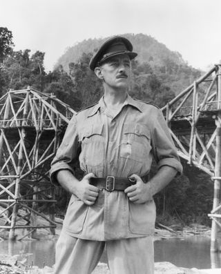 an officer stands by a bridge in the movie The Bridge on the River Kwai