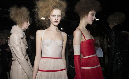 Models in white and red leather dresses