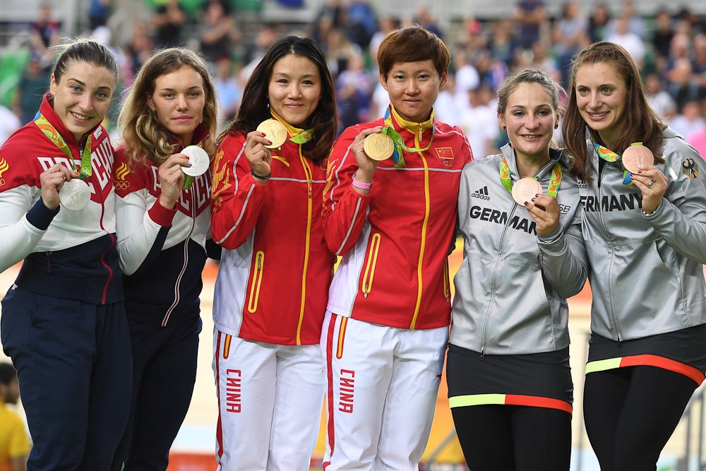 Silver medallists Russia's Daria Shmeleva and Russia's Anastasiia Voinova, gold medallists China's Gong Jinjie and China's Zhong Tianshi and bronze medallists Germany's Kristina Vogel and Germany's Miriam Welte pose on the podium after the women's Team Sprint