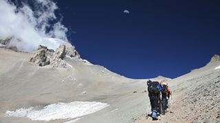 Guided mountaineering team making a carry up to High Camp on Aconcagua, Andes Mountains, Argentina