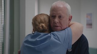 Robyn hugs a sad and worried looking Charlie in Casualty