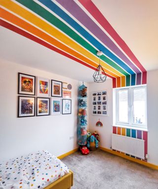 kids' bedroom with rainbow mural
