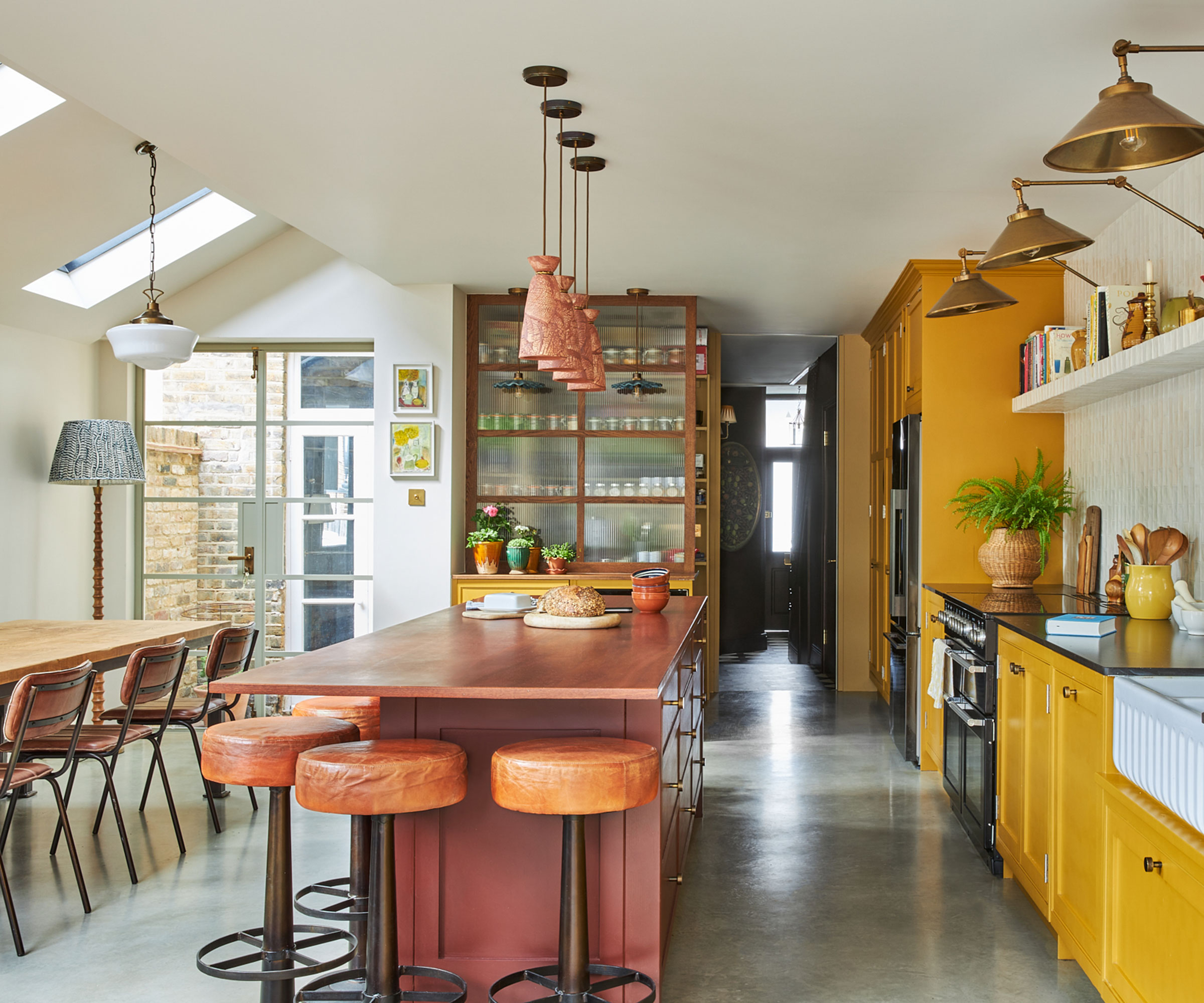 side return kitchen extension with concrete flooring and yellow kitchen units