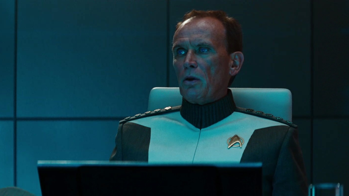 Still from the movie Star Trek into Darkness showing Admiral Marcus in his Starfleet uniform, sat at a desk.