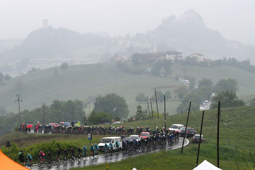 SESTOLA ITALY MAY 11 The Peloton passing through La Stella 705m during the 104th Giro dItalia 2021 Stage 4 a 187km stage from Piacenza to Sestola 1020m Rain Landscape girodiitalia Giro UCIworldtour on May 11 2021 in Sestola Italy Photo by Tim de WaeleGetty Images