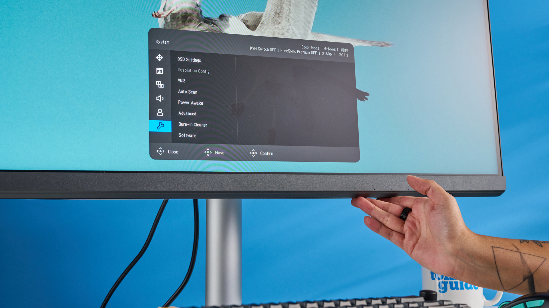 A photo of the BenQ PD3226G monitor in a blue-walled studio