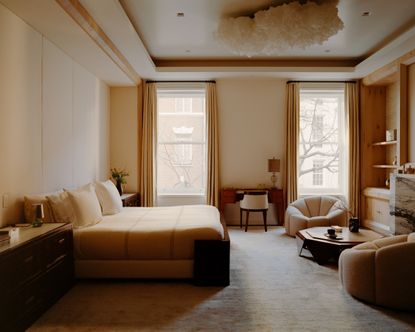 a neutral bedroom with a cloud ceiling light
