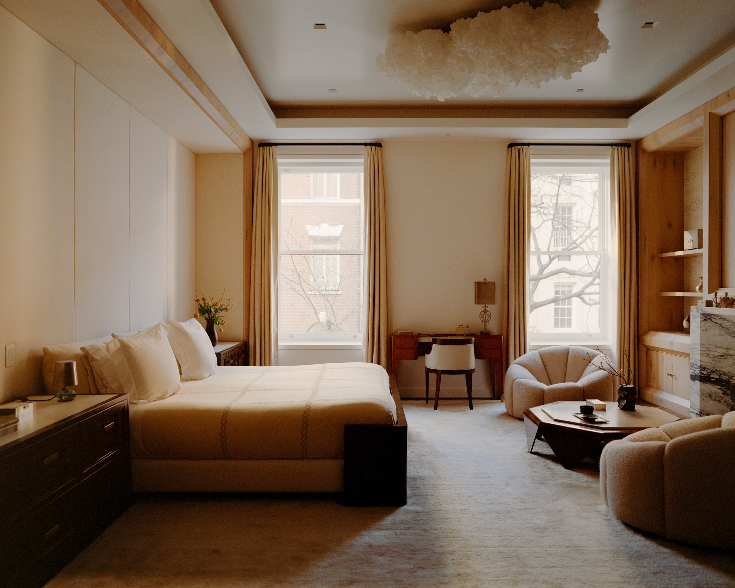 a neutral bedroom with a cloud ceiling light