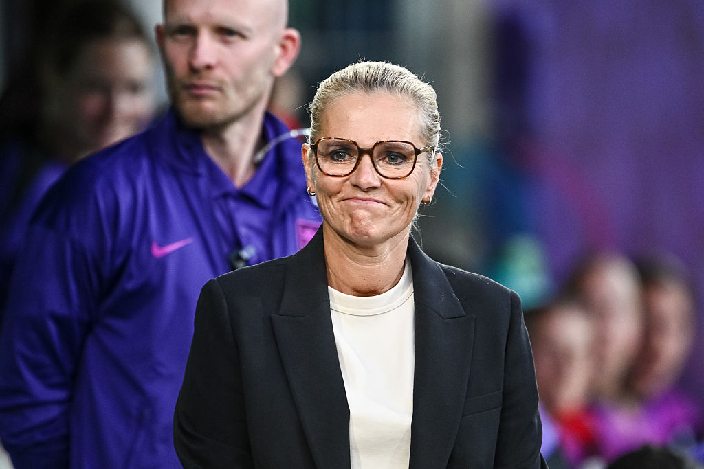 Sarina Wiegman smiling on the touchline