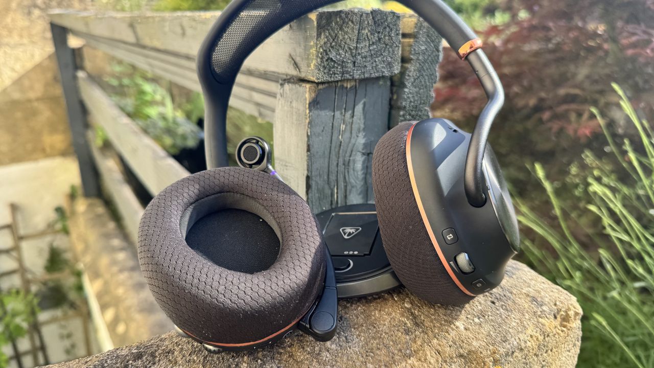 The Turtle Beach Stealth Pro II next to its receiver on rock, outside