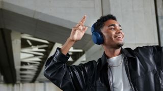Sony WH-XB910N headphones being worn by a person dancing