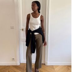 Sylvie Mus wearing a white tank top and trousers.