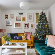 A Christmas tree decorated with brightly coloured baubles in a modern living room