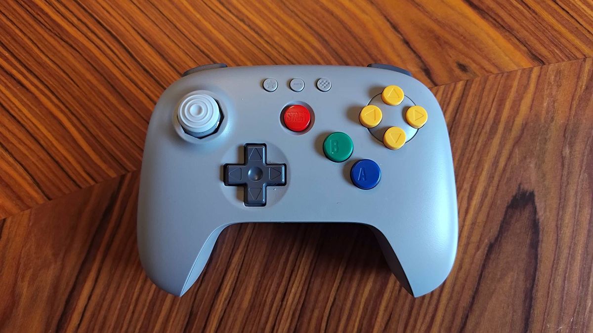 Front view of 8Bitdo N64 controller on woodgrain table.